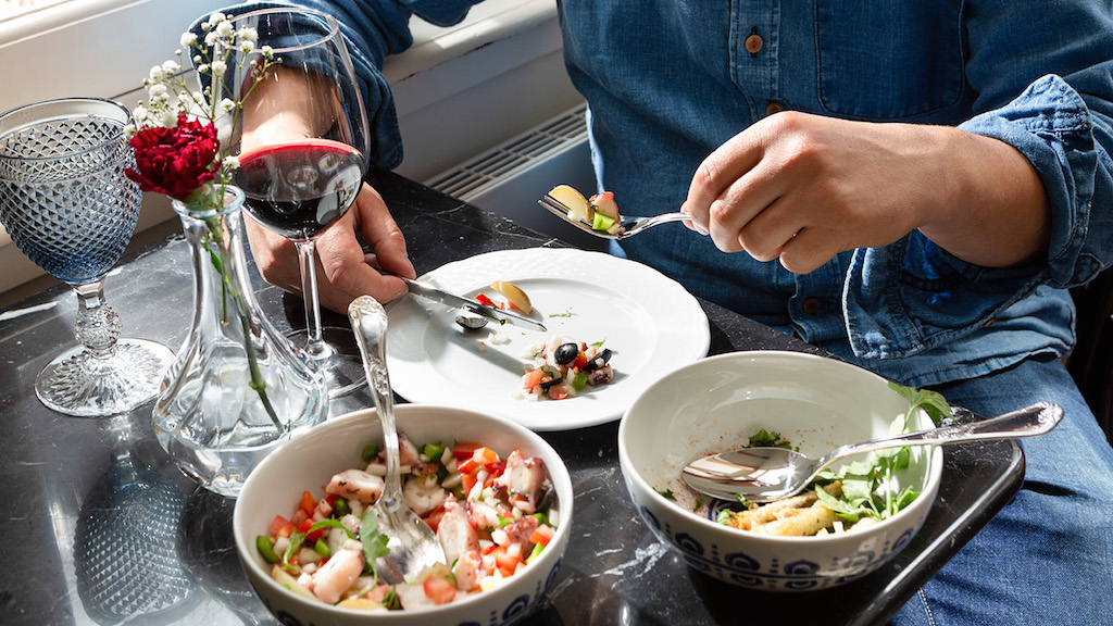 a woman sitting at a table with a plate of food