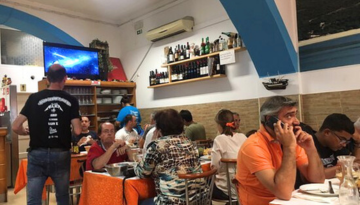 a group of people sitting at a table in a restaurant