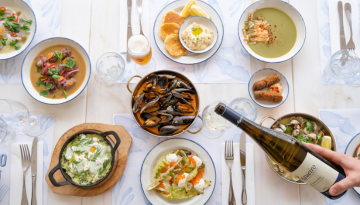 a group of people sitting at a table with a plate of food