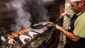 a man cooking on a grill