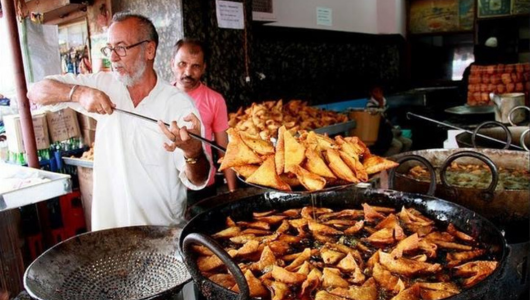 a person cooking in a kitchen preparing food