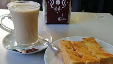 a plate with a sandwich and a cup of coffee