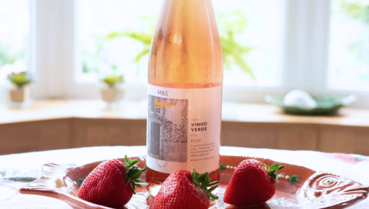 a close up of a plate of food and a bottle on a table