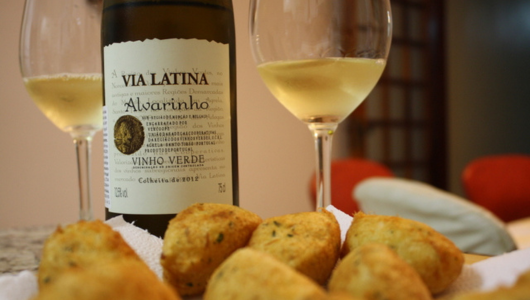 a close up of a plate of food and a glass of wine