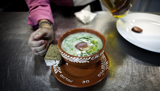 a person sitting at a table with a plate of food