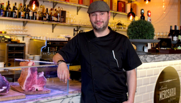 a man standing in front of a cake