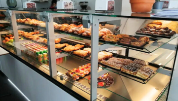 a glass display case with many different types of food