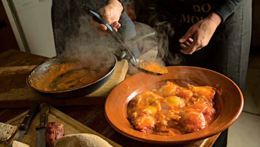 a person cutting food on a table